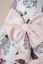 Mona & Milo The Petit Paris Dress displayed on a hanger, featuring a floral pattern