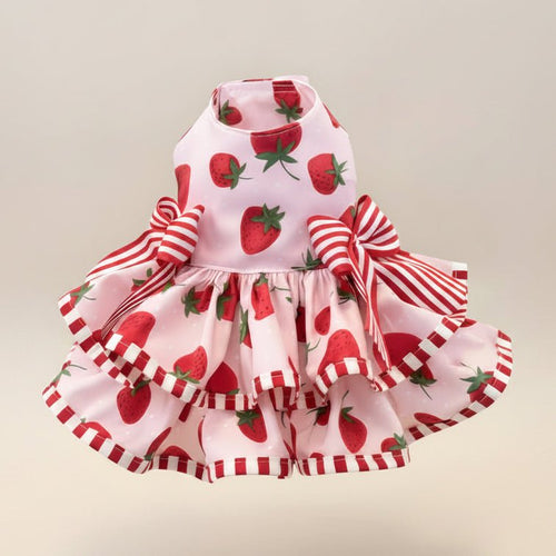 Mona & Milo The Berry Daydream Dress displayed on a hanger, featuring a floral pattern and flowing fabric.