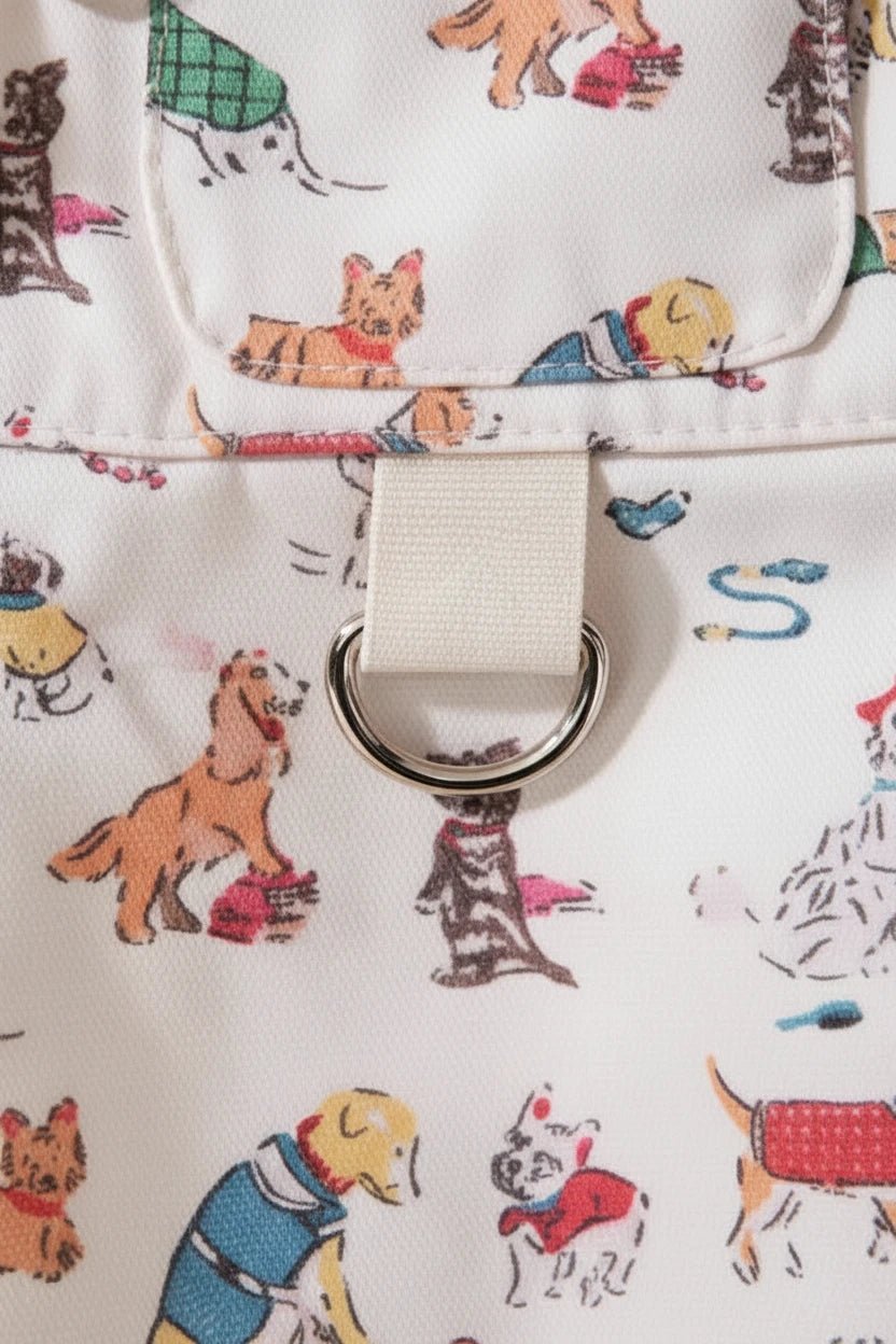 Pippin Cotton Dungaree Dress in white for small dogs — all-over dog print with adjustable suspender straps and D-ring detail