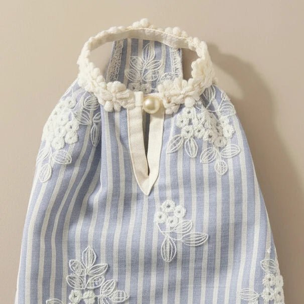 Mona & Milo Elara Embroidered Dress featuring intricate embroidery and a flowing silhouette, displayed on a hanger.