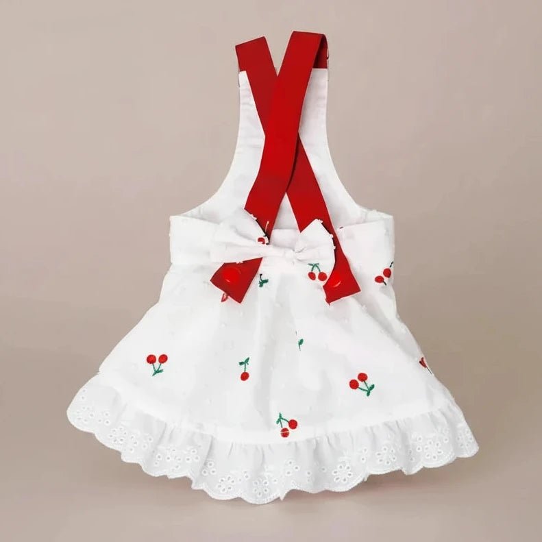 Cherry Twist cotton dress by Mona & Milo, featuring a vibrant cherry print, sleeveless design, and lightweight fabric.