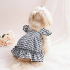 Dog wearing a black and white checkered dress - Mona & Milo
