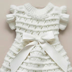 Noelle Bow Knit Dress by Mona & Milo, featuring a cozy knit fabric and a stylish bow detail, displayed in a fashion shot.